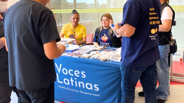 Representatives from Voces Latinas draw a crowd around their table during Apicha’s annual National Health Center Week Health Fair